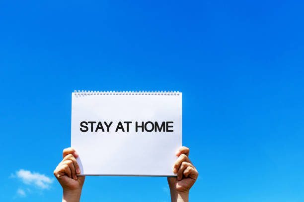 istock Hands holding paper note with Stay at home text 1250516819
