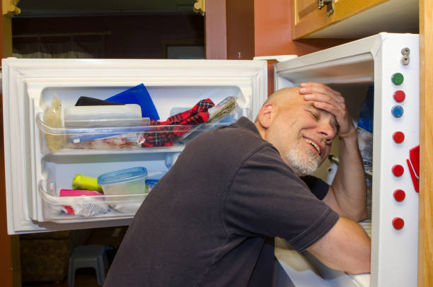 istock Man with head in freezer during heat wave 1250518070