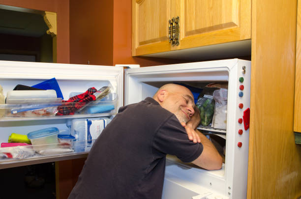 istock Man with head in freezer during heat wave 1250518084