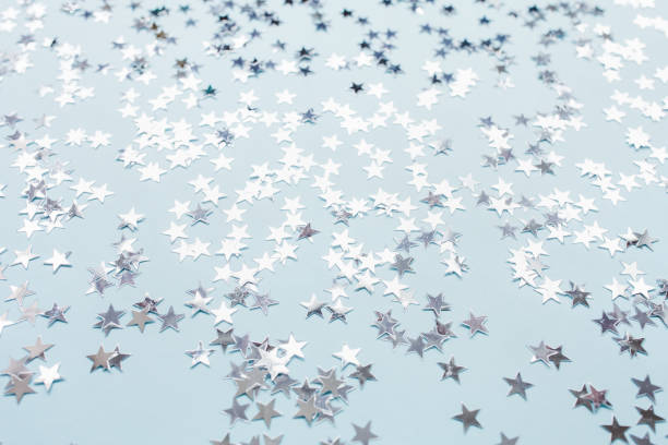 istock Silver foil confetti stars on blue background 1250521424