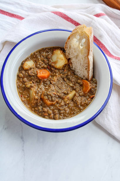 istock Lentil soup with vegetables and potatoes. Typical Spanish lentil soup. 1250521494