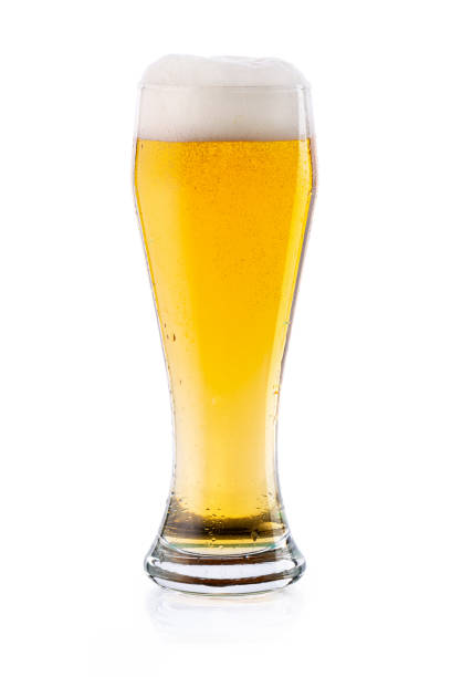 istock Cold light lager beer with drops and foam in glass. isolated 1250523650