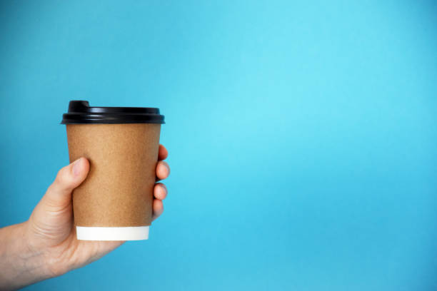 istock Hand holds cardboard cup of coffee 1250525834
