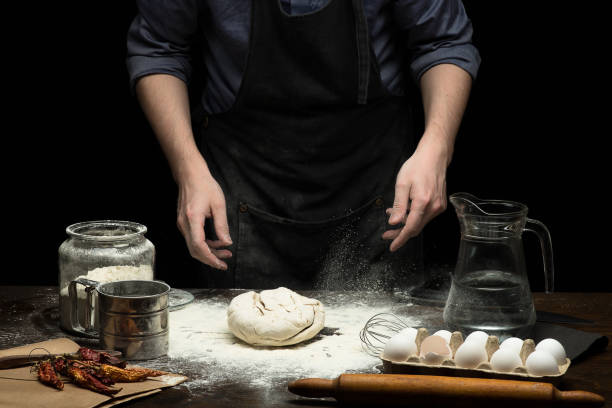 istock Hands are kneading the dough on wooden table 1250525967
