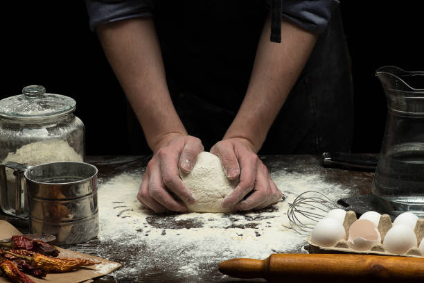istock Hands are mixing a dough on wooden table 1250526040