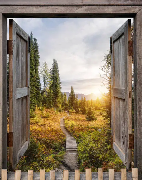 Photo of Antique wooden windows open to autumn wilderness at sunrise