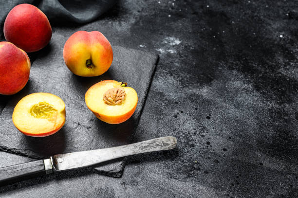istock Organic Peaches fruit on a black stone Board. Black background. Top view. Copy space 1250529840