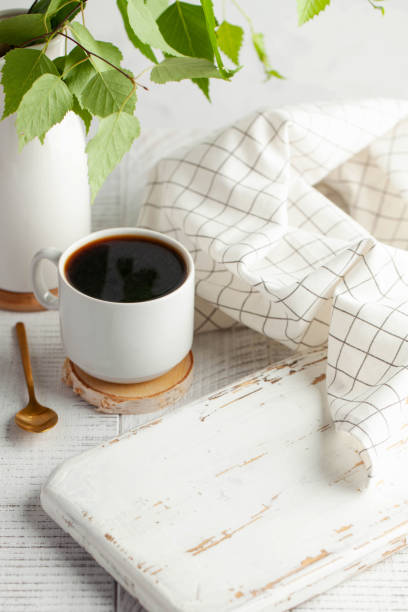 istock A white mug with black coffee, a branch with green leaves, an empty Board, a place to insert your product. Copy space 1250530785
