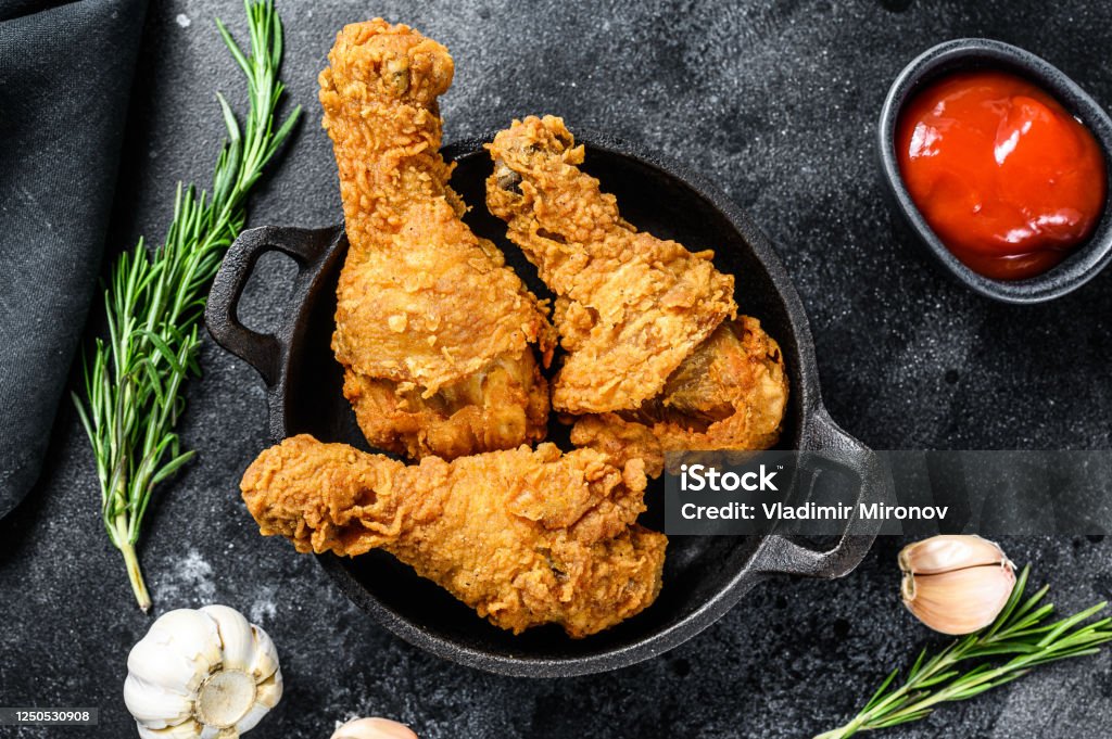 Spicy Deep Fried Breaded Chicken drumsticks. Black background. Top view Spicy Deep Fried Breaded Chicken drumsticks. Black background. Top view. Fried Chicken Stock Photo