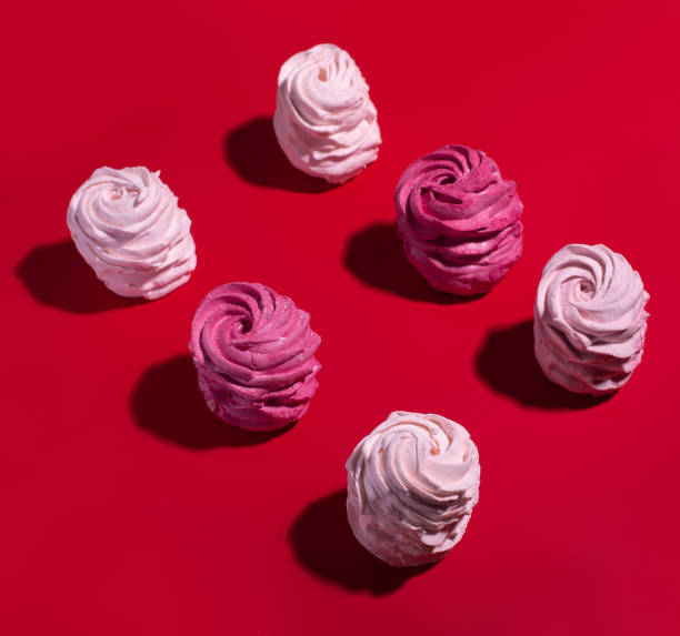 istock set of colorful meringue on red background 1250531253
