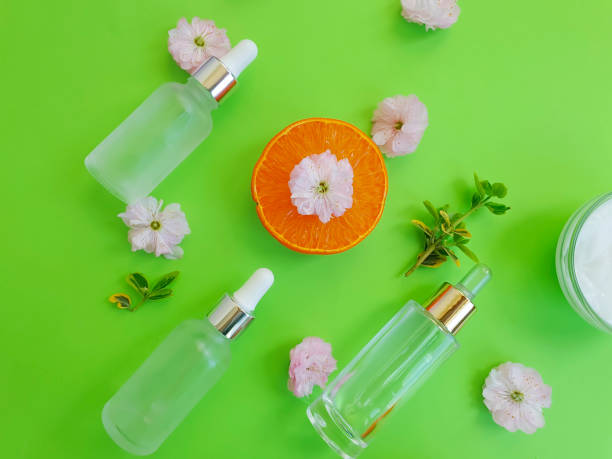 istock cosmetic serum, flower on a colored background 1250532976