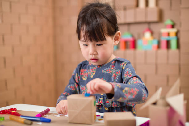 istock toddler girl  making craft by using cardboard for homeschooling 1250533040