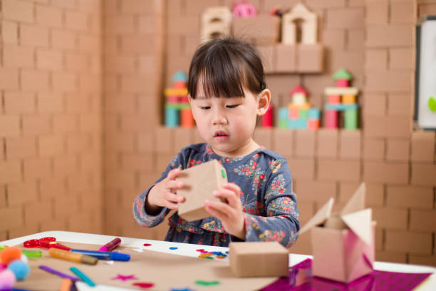 istock toddler girl  making craft by using cardboard for homeschooling 1250534703