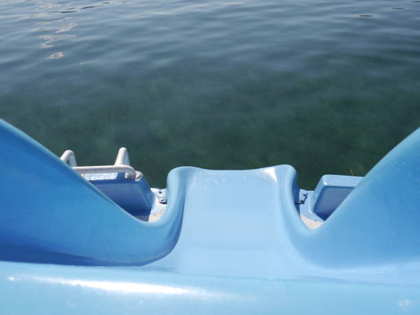 Blue plastic slide to sea water surface under the bright sun