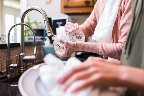 istock Unrecognizable mother and son wash and dry dishes 1250538334