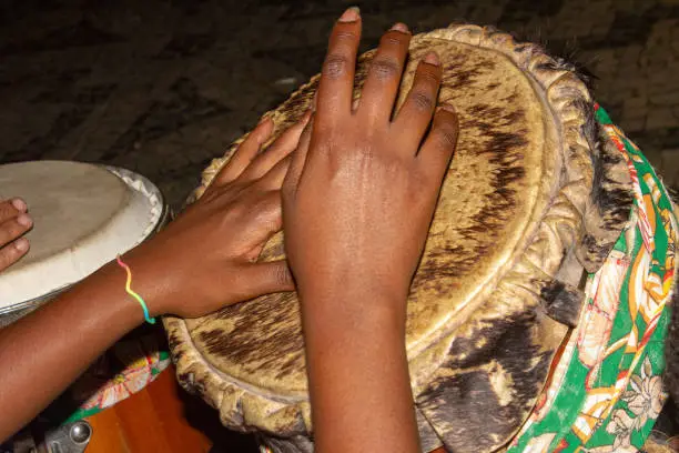Hands of a black woman playing the drum during a jongo performance (a type of dance of African origin accompanied by drums) in Rio de Janeiro.