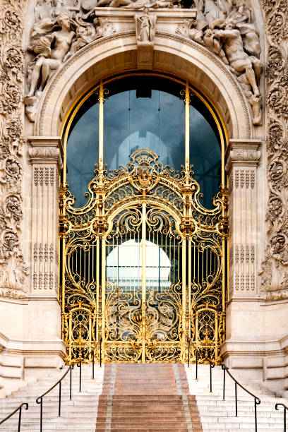 The Petit Palais built for the world exposition in 1900, it now houses the City of Paris Museum of Fine Arts. The beautiful golden door is closed and the street is empty during epidemic Covid19 virus in France. Located Avenue Winston Churchill, near Champs Elysees, Pont Alexandre III, on Right Bank. Paris, in France. May 5, 2020.