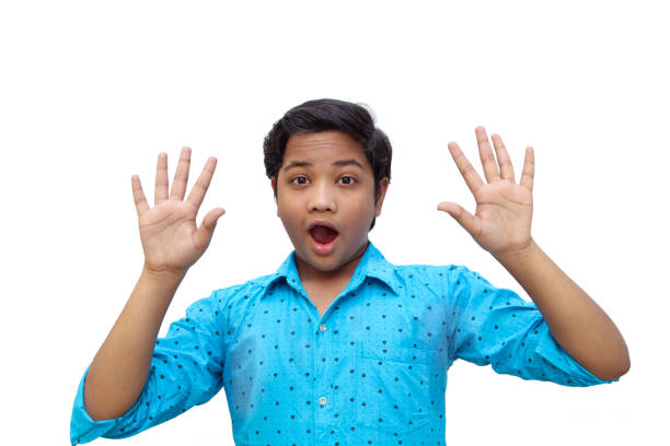 istock Hand,fingers,shocking,face,a boy gave shocking expression with hands and finger with white background 1250543211