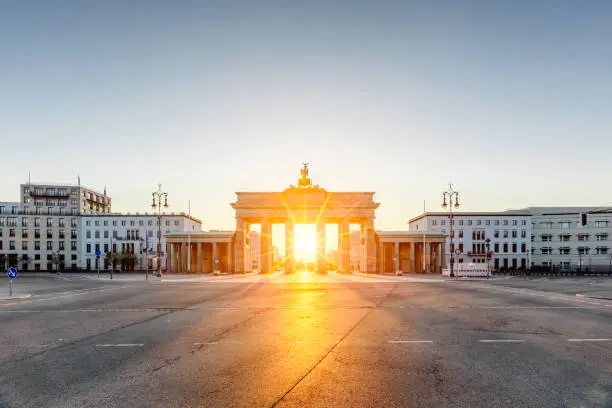 Beautiful sunrise directly behind Brandenburg Gate, Berlin, Germany