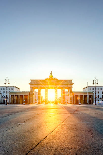 istock Beautiful sunrise directly behind Brandenburg Gate, Berlin, Germany 1250549154