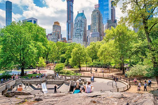 People relax in Central Park, Manhattan, New York City, USA on a sunny day