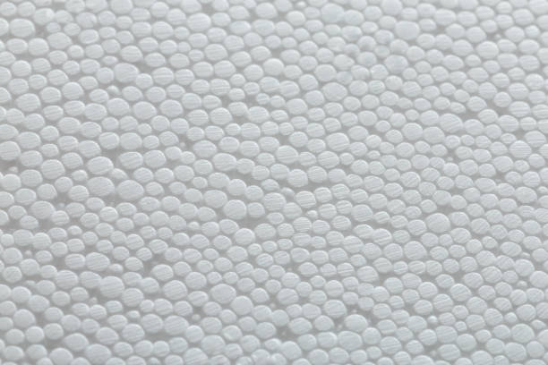 istock Simple close-up flat but bumpy background of white polystyrene foam or styrofoam, white on white backdrop with selective focus and partial blur. 1250550182