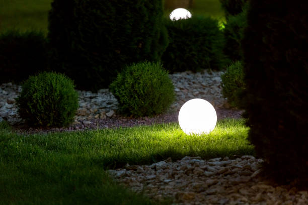 istock illumination backyard light garden with electric ground lantern with round diffuser lamp in lawn in outdoor park with landscaping thuja bushes in stone mulching, dark illuminate night scene nobody. 1250557231