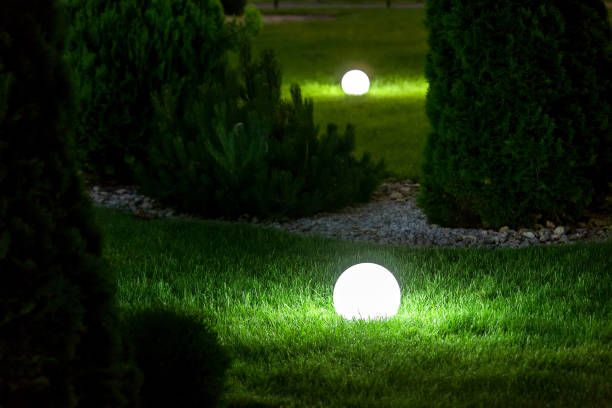 istock illumination backyard light garden with electric ground lantern with sphere diffuser lamp in the green grass lawn in outdoor park with landscaping, dark patio illuminate night scene nobody. 1250557240
