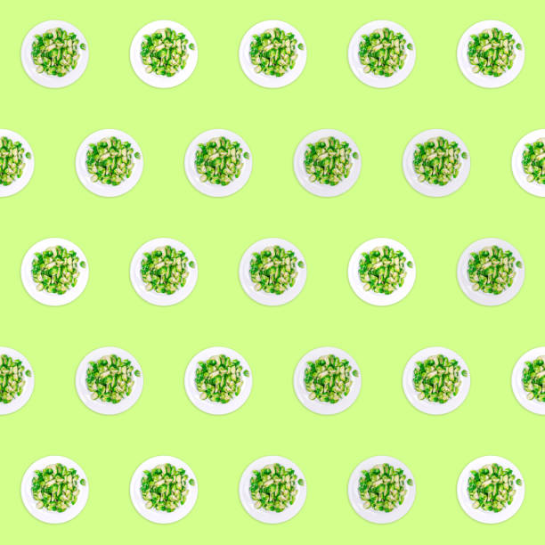 istock Pattern of plates with lightly fried brussels sprouts on the neon green drop 1250558439