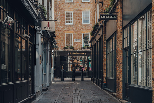 London, UK - June 13, 2020: Empty street and closed shops and restaurants in Soho, a famous tourist area in London with numerous of shops and restaurants, selective focus.