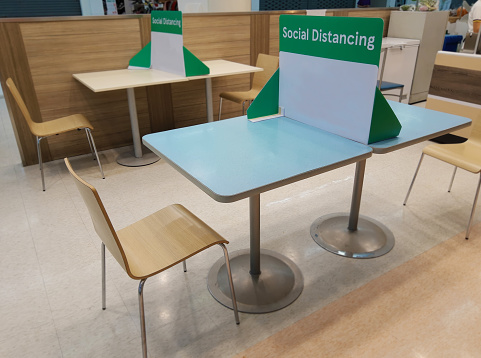 Distance protect from COVID-19 viruses and people social safety in Public food center There is a partition on the dining table.To Maintain distance between people.