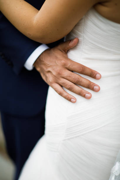 istock Couple. You can see the hands touching each other. 1250567079