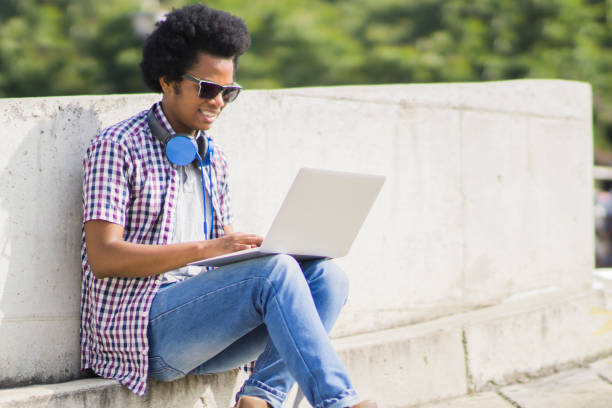 istock African American man working outdoors on a laptop computer 1250569648