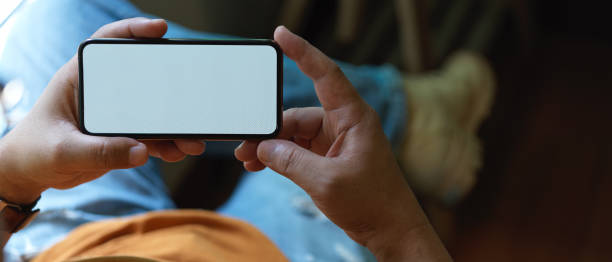istock Male freelancer resting with horizontal mock-up smartphone while lying relaxed on office chair 1250571299