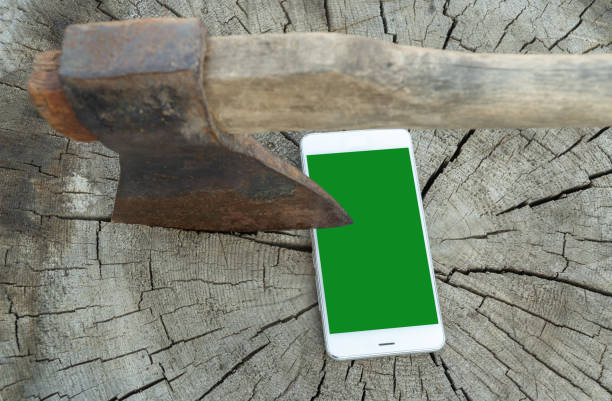 modern cell phone and a rusty axe. Selective focus. The concept of refusing to use gadgets. digital devices detox