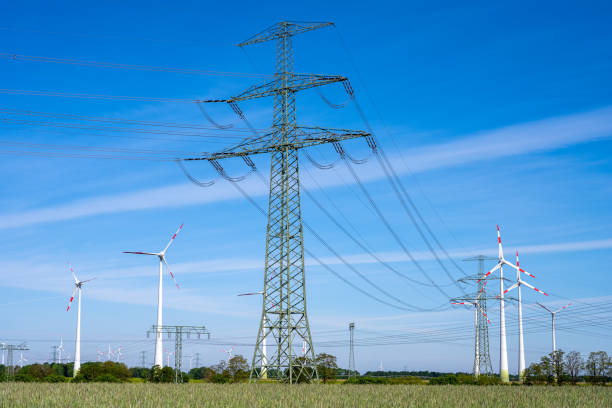 istock Overhead power lines and wind turbines 1250583802