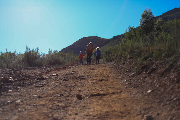 istock A single mom walking with her boys up a steep rocky road 1250583858