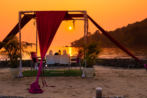 gazebo for relaxing on the beach at sunset, a romantic dinner in the privacy