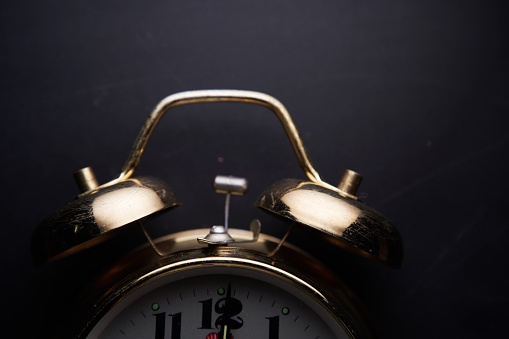 antique alarm clock on blockboard