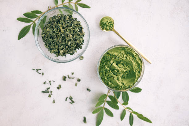 istock Green moringa leaf powder. Moringa leaf tea. green powder on white background 1250590894