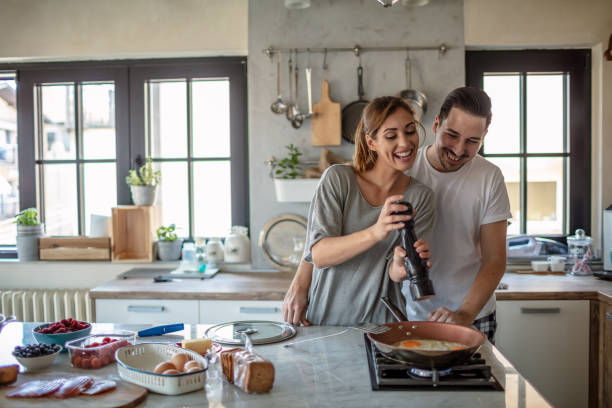istock Making eggs for breakfast. Young couple in the kitchen 1250592433