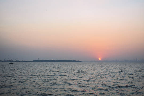 istock Sunset beside the ocean near Mumbai shore 1250592454