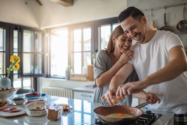 istock Making eggs for breakfast. Young couple in the kitchen 1250592625