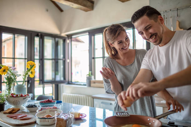 istock Making eggs for breakfast. Young couple in the kitchen 1250592668