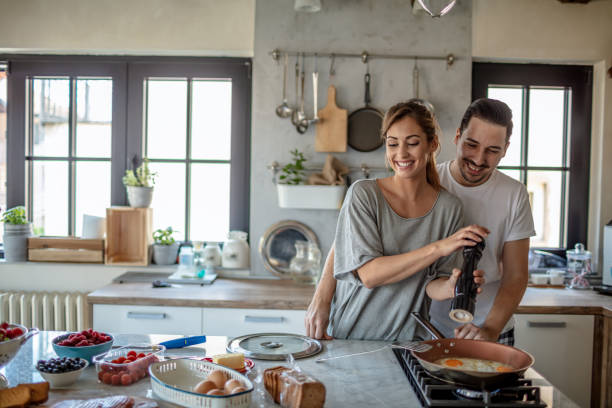 istock Making eggs for breakfast. Young couple in the kitchen 1250592705