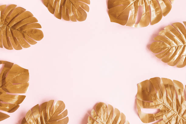 istock Summer composition. Tropical golden leaves on pink background. Summer concept. Flat lay, top view, copy space 1250593616