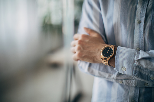 Classic analog men's wrist watch on white background. Close up.