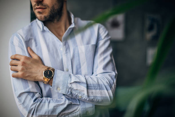 istock Modern man with gold wristwatch 1250596040
