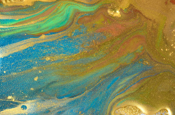 istock Golden dust background with ink stains. Sparkling gold texture. 1250596085