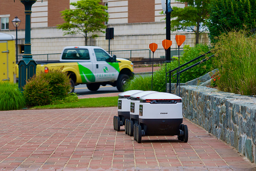 Fairfax, Virginia / USA - June 17, 2020: Autonomous delivery robots made by Starship Technologies await orders to pick up and deliver food to their next destination in Old Towne Square in the historic City of Fairfax.